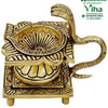Naga Swastik Deepam / Lamp - Brass, a gold-toned metallic figurine featuring a lotus-shaped bowl and a coiling serpent handle on a square base