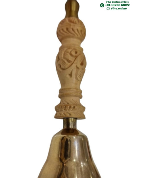 Kasi Pooja Bell, brass bell with a pale carved handle turned in rings with leaf and fish motifs