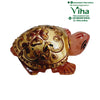 Rose Quartz Turtle, a pink turtle figurine featuring a shiny gold-toned shell carved with a red four-petal flower and scrollwork