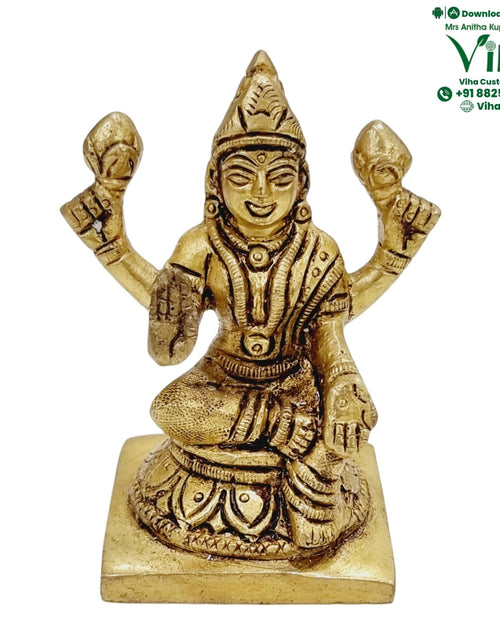 Mahalakshmi in brass, four-armed figure seated on a square base with the upper hands raised