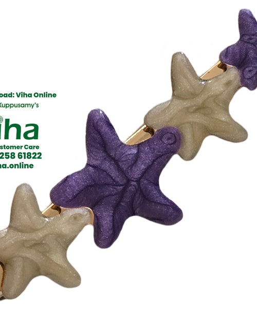 Star Hair Clip, a gold-toned barrette featuring four alternating purple and off-white starfish shapes with textured surfaces arranged in a diagonal line