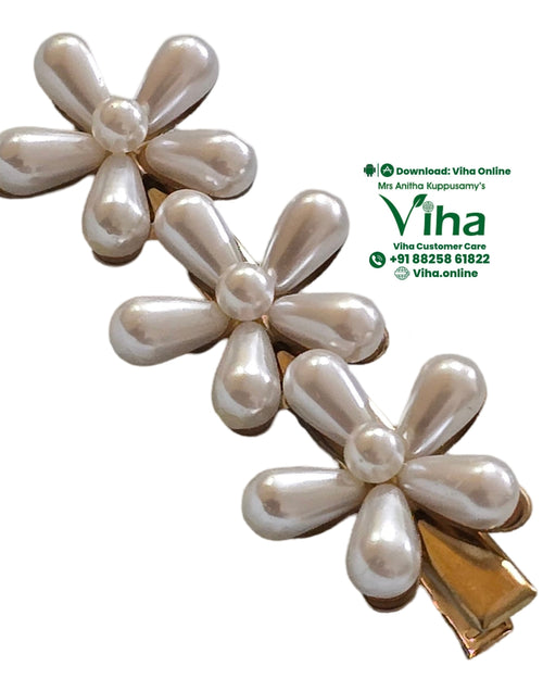 White Flower Hair Clip, three white pearl-like flower motifs with five teardrop petals and a central sphere on a gold-toned base
