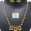 White Beads Lotus Pendant Chain Set, a gold-toned jewelry set with white beads, red, green and clear stones against a black background