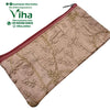 Designer Purse, a rectangular pinkish-beige zippered pouch featuring gold-toned embroidered tree branches and leaves patterns across its shiny surface