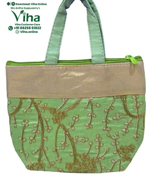 Designer Bag with dual green fabric handles and zipper closure
