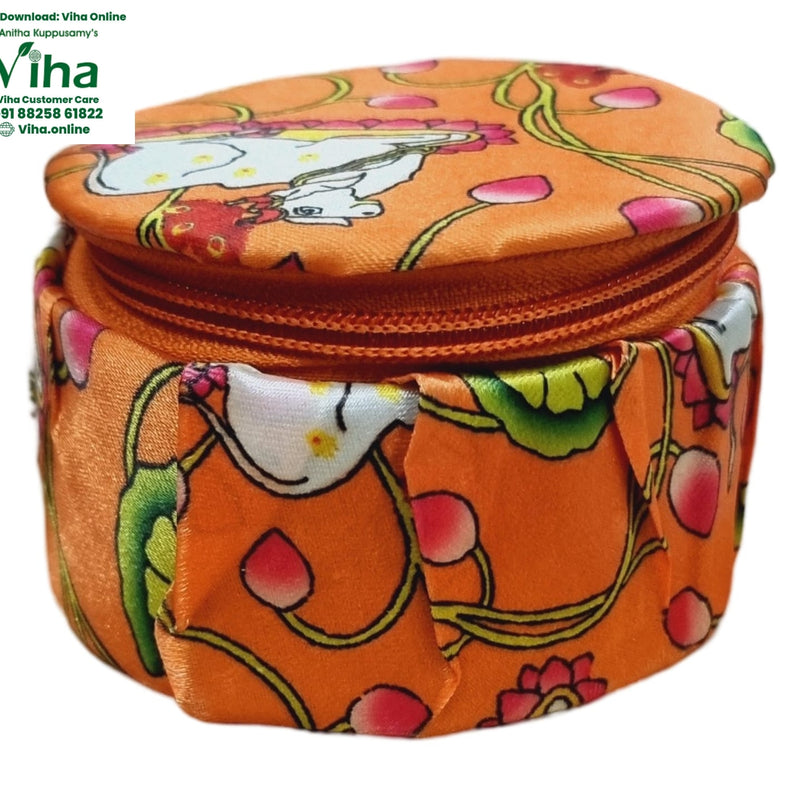 Storage Box, an orange fabric round zipped box with floral and white figure prints