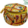 Storage Box, a round yellow zippered pouch featuring a red, white, and green geometric pattern fabric and one yellow plastic zipper pull