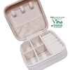 Travelling Jewel Case, an open beige textured zip case interior features three hooks, a gathered pocket, four compartments, and six slotted rolls