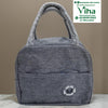 Thermal Lunch Bag, a grey textured fabric handbag featuring two woven top handles, a front slip pocket, and a circular patch in the bottom right corner