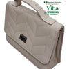 Stylish Ladies Sling Bag, light beige handbag featuring a chevron-quilted flap, single top handle, and a dark metallic rectangular clasp on the front