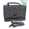 Stylish Ladies Sling Bag, a grey handbag featuring chevron quilting, a top handle, a metallic clasp, and a folded patterned strap with two clasps