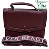 Sling Bag For Ladies, a maroon handbag with a top handle and a folded strap featuring white text