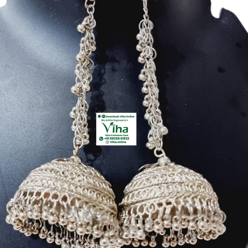 White Metal Long Jhumka, two long silver-toned jhumka earrings featuring peacock studs and beaded chains