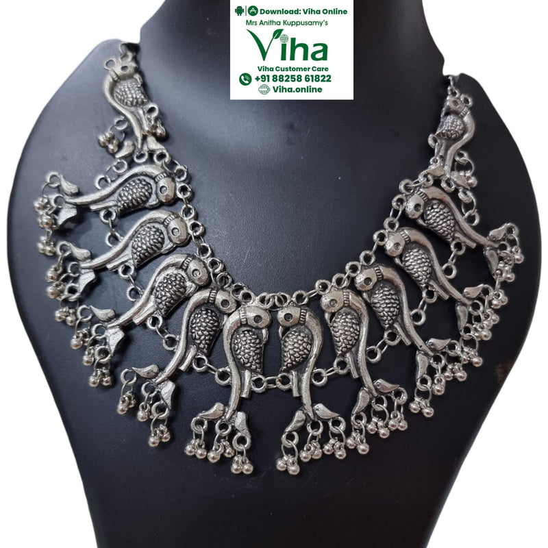 White Metal Oxidised Peacock Necklace with bird motifs and hanging bell accents