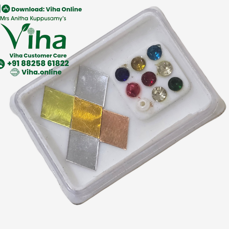 Vastu Panchaloha Set, a white plastic box containing four metallic squares and ten assorted colorful stones arranged on a white insert