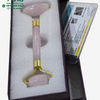 Rose Quartz Face Roller, a pink stone massage tool with gold-toned metal accents rests in a foam-lined purple box alongside a certification card