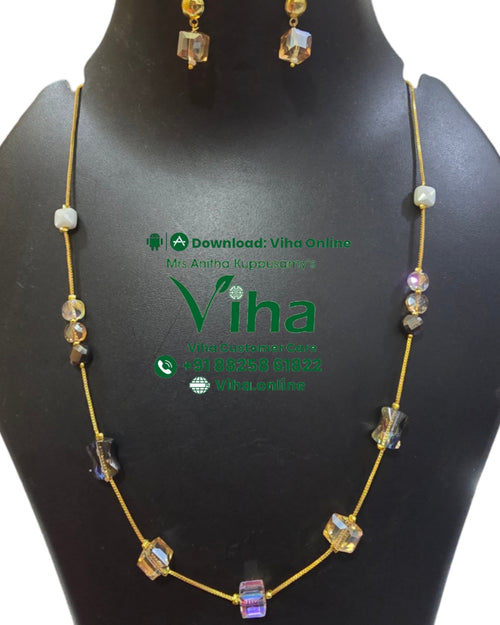 Trendy Crystal Chain Set, a gold-toned chain necklace with ten mixed-shape beads and two matching drop earrings displayed on a black stand