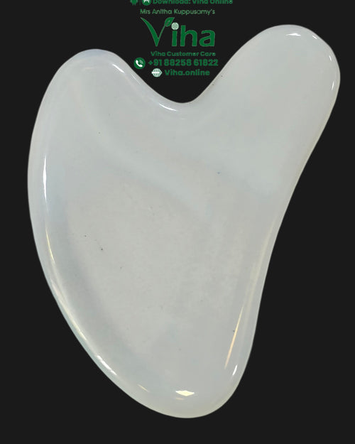 Opal Guasha, a glossy white heart-shaped object against a black background