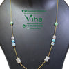 Trendy Chain Set, a gold-toned chain necklace with multicolored beads and matching drop earrings on a black display bust