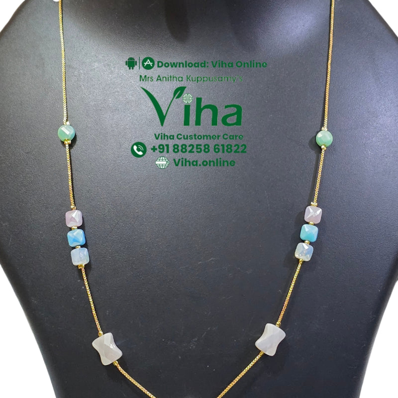 Trendy Chain Set, a gold-toned chain necklace with multicolored beads and matching drop earrings on a black display bust