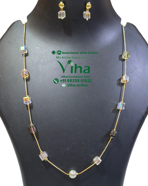 Trendy Crystal Chain Set, a gold-toned chain necklace and earrings featuring nine multicolored cubic beads and one white bead centered on the necklace