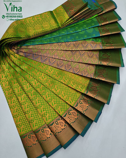 Semi Silk Saree, a folded green-and-yellow fabric with orange-brown brocade patterns and borders is arranged fanwise on a white surface