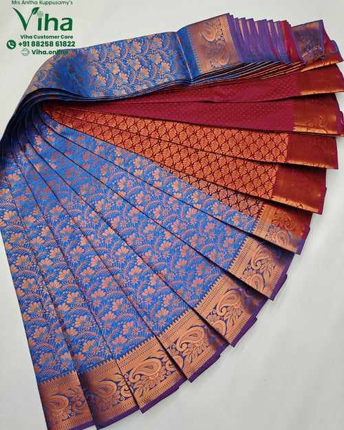 Semi Silk Saree, a fan-folded blue, red, and orange fabric featuring intricate floral and paisley patterns with a glossy metallic sheen on borders