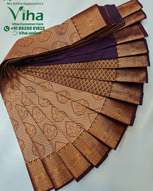 Semi Silk Saree, a fan-fold of purple fabric features gold-toned patterned borders and repeating motifs across beige and purple surfaces