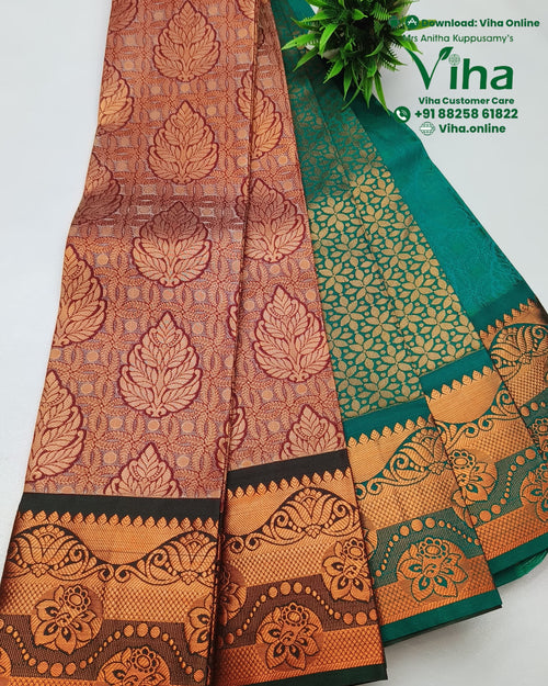 Semi Silk Saree, a folded fabric with a shiny copper-toned leaf pattern and a green section featuring small gold-toned motifs and a decorative border