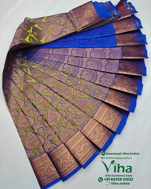 Silk Saree, a pleated blue and green fabric with copper-toned patterned borders and intricate motifs arranged in overlapping folds