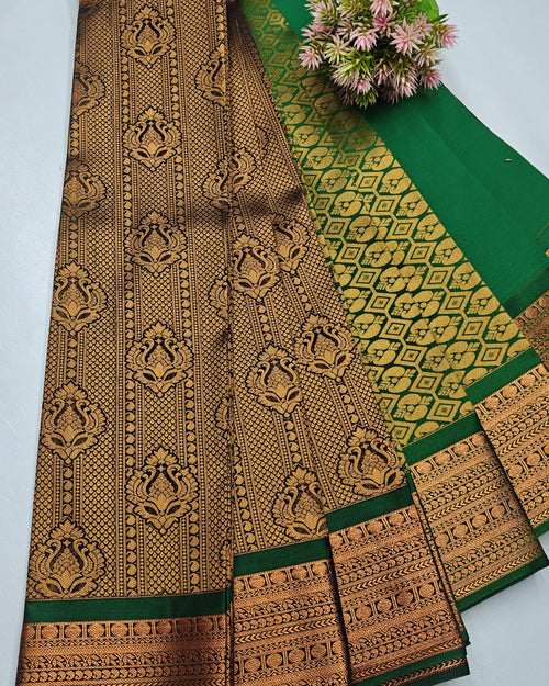 Silk Saree, a folded green fabric with a wide gold-toned patterned border and a small cluster of pink flowers resting near the top
