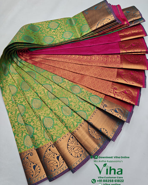 Silk Saree, folded green-and-pink fabric with shiny metallic gold-toned woven floral and peacock patterns displayed stacked against a white background