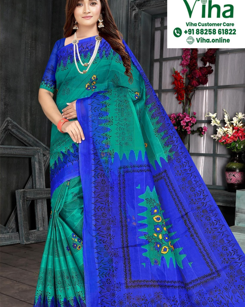 Super Net Cotton Saree With Blouse, a woman standing wearing a blue and green printed saree with black floral patterns and two layered necklaces