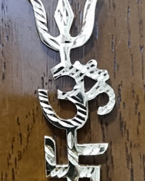 Trishakthi Wall Hanger Brass, a silver-coloured metallic pendant featuring a trishula, an Om symbol, and a swastika stacked vertically