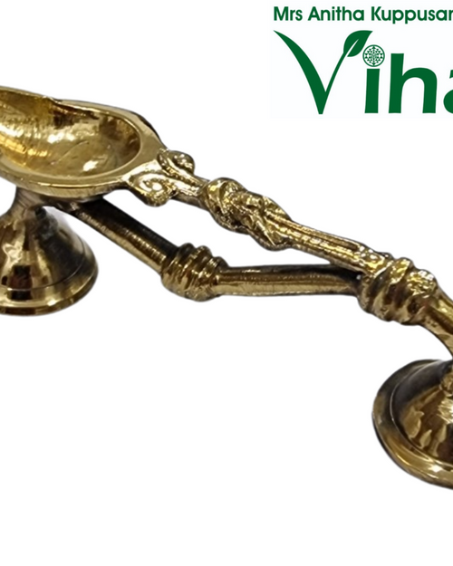 Pooja Arthi Stand / Dhoop Stand, a shiny gold-toned metal object with two conjoined handles extending between two conical pedestal bases