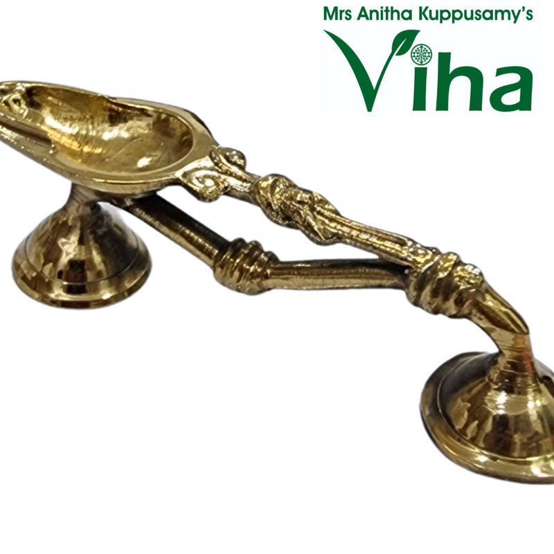 Pooja Arthi Stand / Dhoop Stand, a shiny gold-toned metal object with two conjoined handles extending between two conical pedestal bases