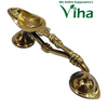 Pooja Arthi Stand / Dhoop Stand, a shiny gold-toned metallic vessel with two flared conical bases and a curved, ornamented handle connecting them