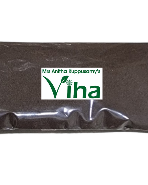 Pirandai Uppu, a rectangular sealed transparent plastic pouch filled with dark brown fine powder and bearing a rectangular white sticker with green graphics