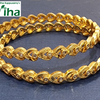 Impon Bangle, two gold-toned metal bangles feature interlocking leaf or heart-shaped links, inset with clear stones