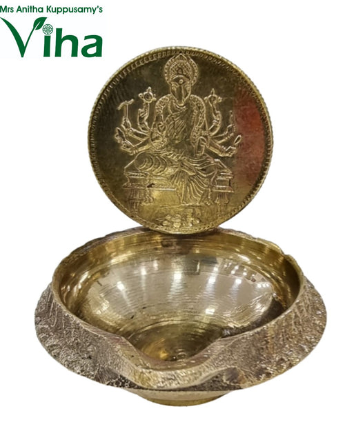 Varahi Amman vilakku, embossed Varahi disc standing behind a deep textured brass oil bowl