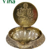 Varahi Amman vilakku, embossed Varahi disc standing behind a deep textured brass oil bowl