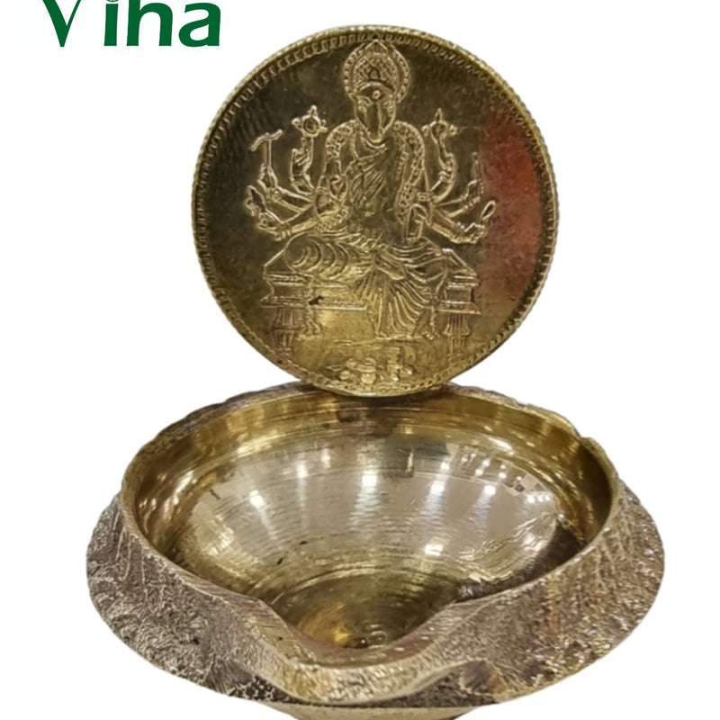 Varahi Amman vilakku, embossed Varahi disc standing behind a deep textured brass oil bowl
