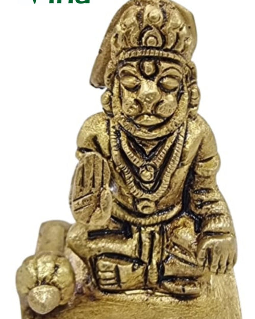 Hanuman in brass, kneeling figure with a pointed crown and hands folded, a rounded form at the side