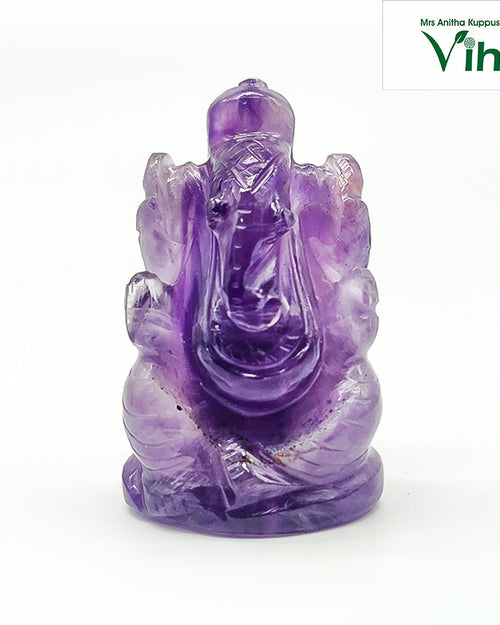 Amethyst Ganesha with a seated elephant figure carved from purple crystal