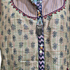 Fancy Long Gown, a green and pink patterned tunic with a button placket featuring colorful beads and a beaded tassel fringe