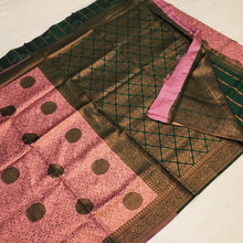Soft Silk Saree With Blouse, a folded pink and green fabric featuring gold-toned patterned borders and circular motifs over the surface