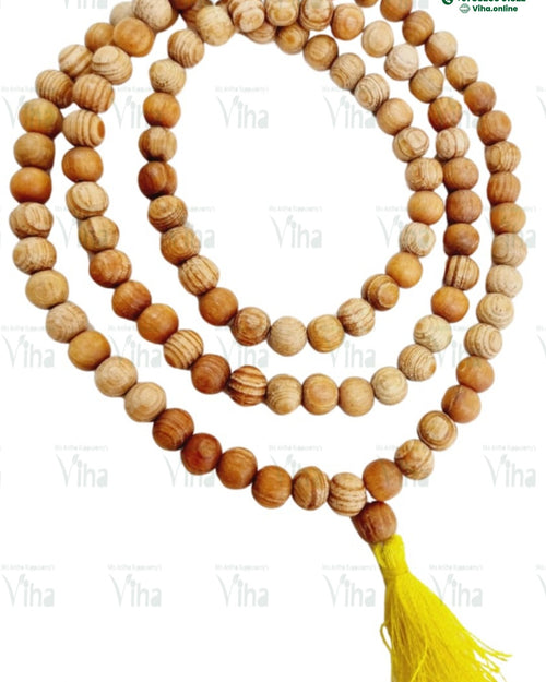 Devadaru Wood Mala Original (Deodar / Cedar Wood) / Devadharu, a strand of round, tan-striped beads ending in a yellow tassel