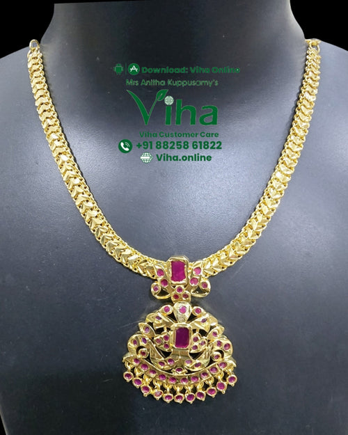 Aimpon Attiyal, a gold-toned textured chain necklace with a ornate pendant featuring red stones and hanging bead details