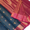 Semi Soft Silk Saree With Blouse - VIHA : 0062, a folded textile featuring a dark teal section with gold-toned motifs and a magenta-toned section