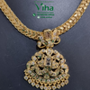 Impon Attiyal, a gold-toned metal necklace featuring a flat herringbone chain and a large ornate pendant set with clear stones and dangling round elements